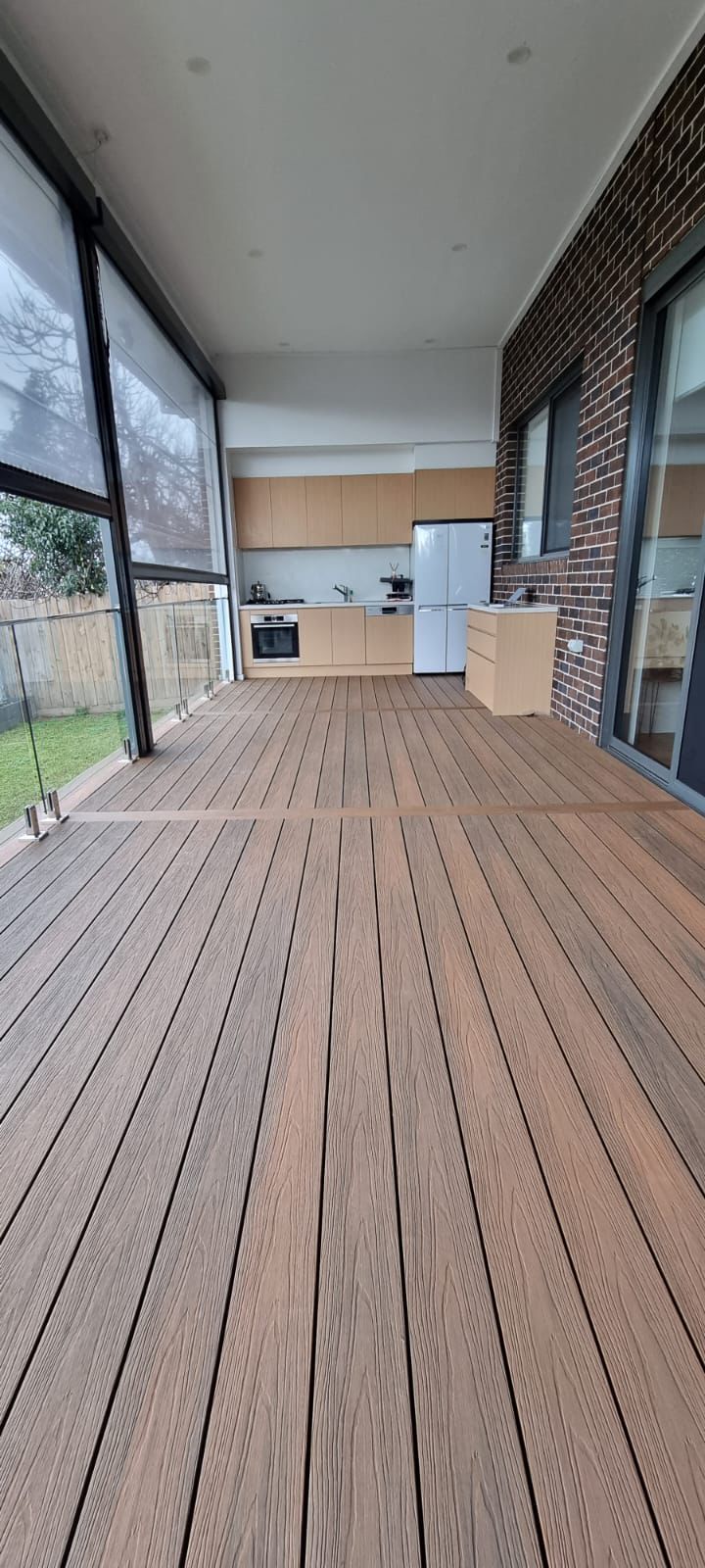 Composite alfresco decking running out from an outdoor kitchen